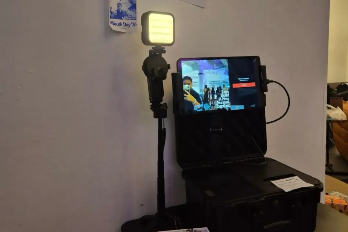 Memory Vault set up for Youth Day '26: a light panel and tablet on a stand above the open printer case.